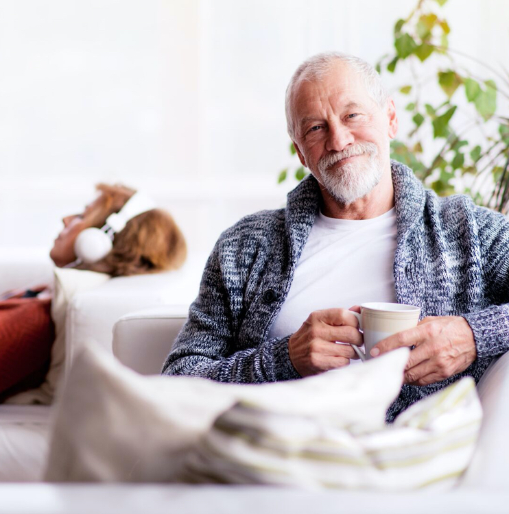 man enjoying coffee on couch