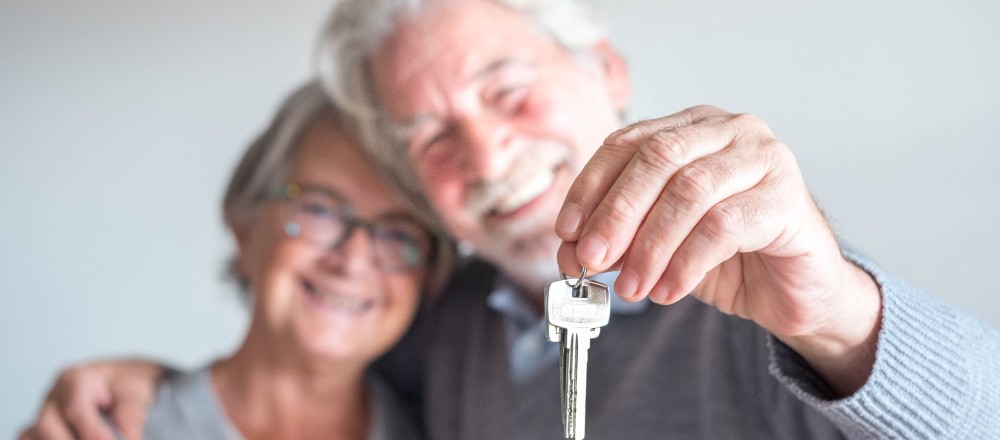 senior couple holding apartment keys