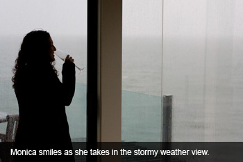 Monica smiles as she takes in the stormy view.