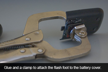 The flash foot being attached to the battery cover of the PhotoTrackr.