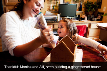 Monica and Alli making a gingerbread house.