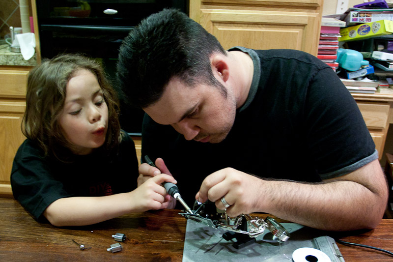 Alli and doing a little soldering on the kitchen table