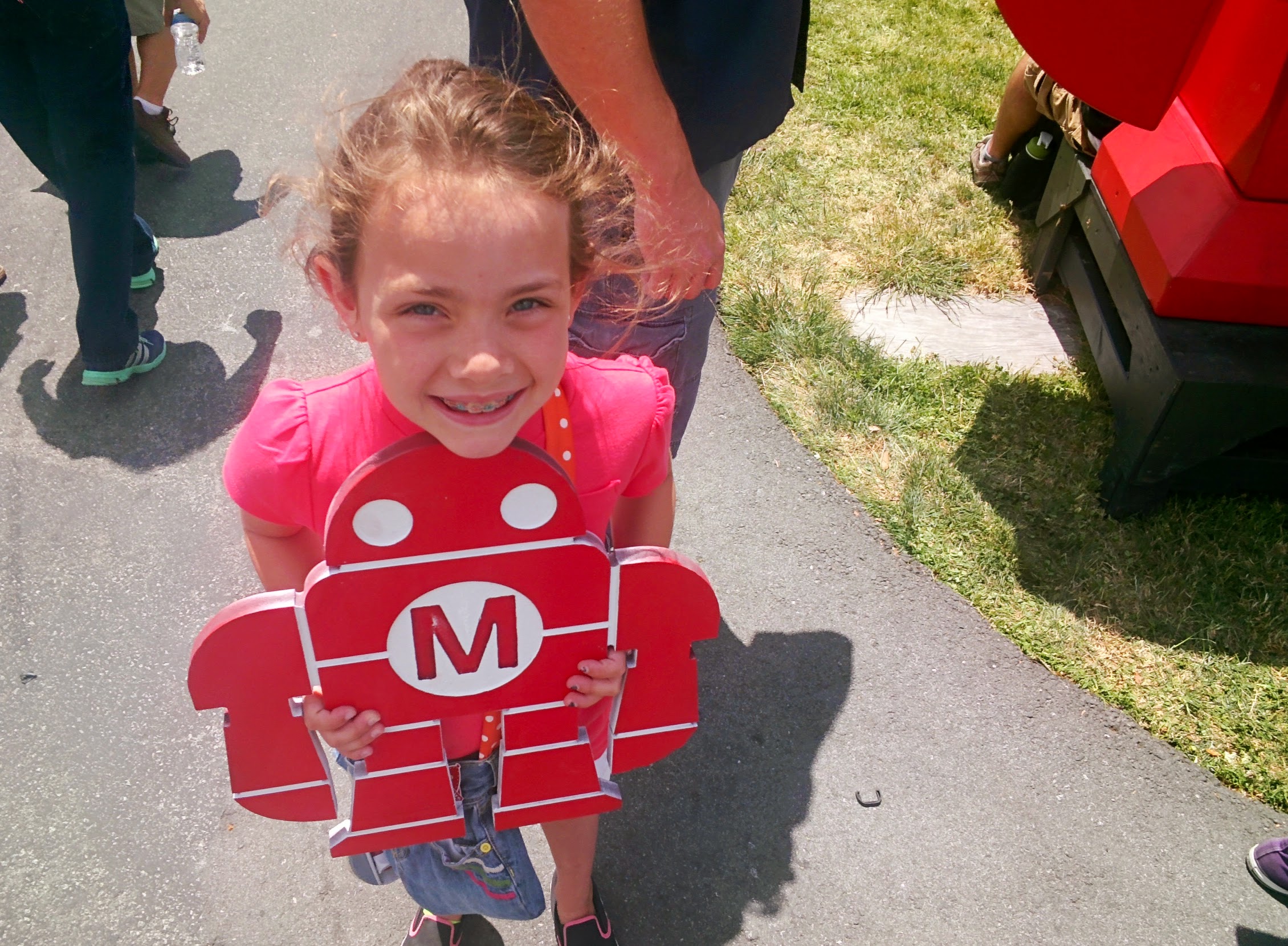 Alli holding a cutout of Make's robot.