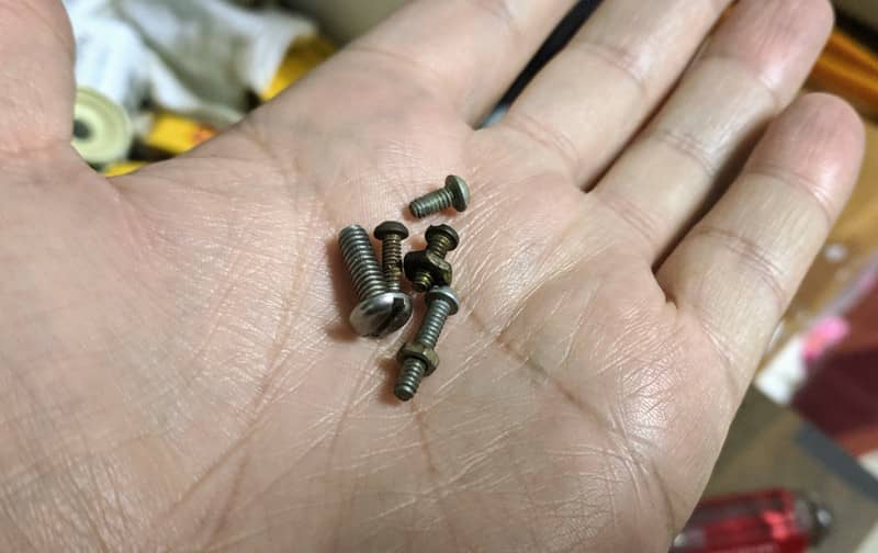 An odd collection of screws that came with the enlarger but are not the correct sizes or lengths.