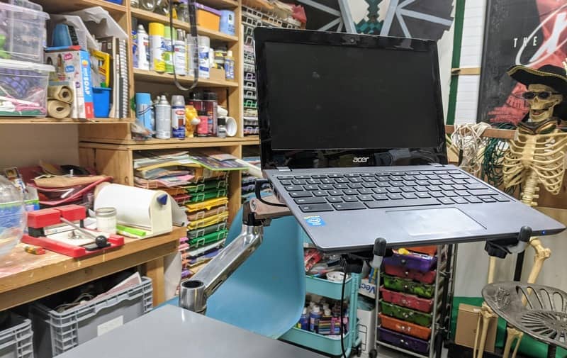 A laptop floats effortless on the machine table mounted Ergotron LX arm.