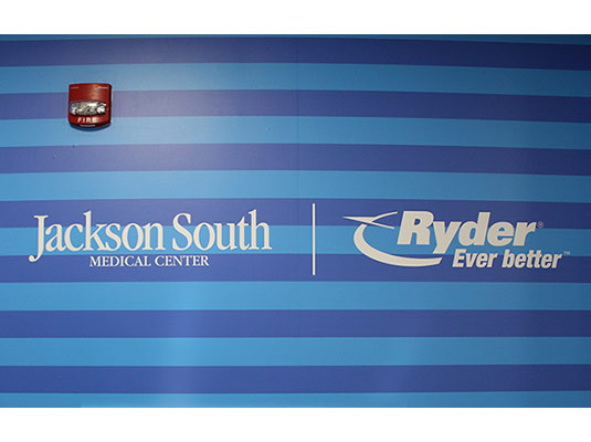 Jackson South Medical Center and Ryder logos on a wall