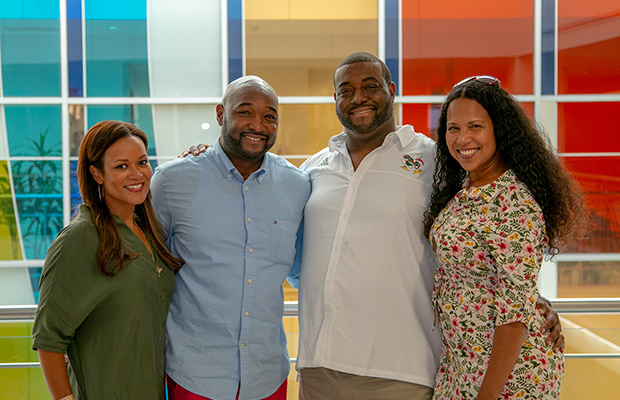 Two man and two woman smiling, they are standing next to each other