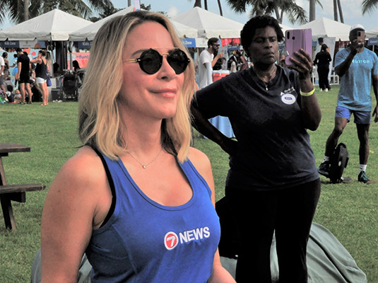 A closeup of a woman who is looking forward, she has on a 7 news shirt