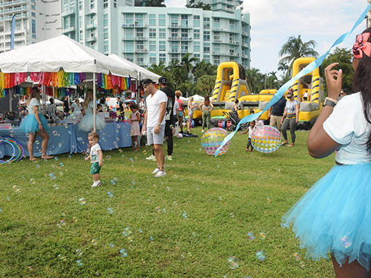 A child playing outside, there are bubbles around him