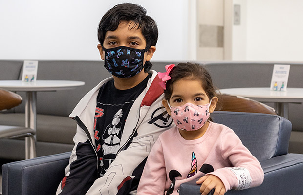 Two young children sitting next to each other