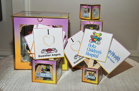 Boxes and small signs that read Holtz Children's Hospital and I Love Guardian Angels