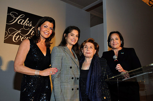Four women standing on a stage