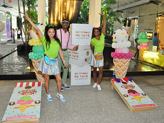 Three people standing around Ice Cream We Love signs