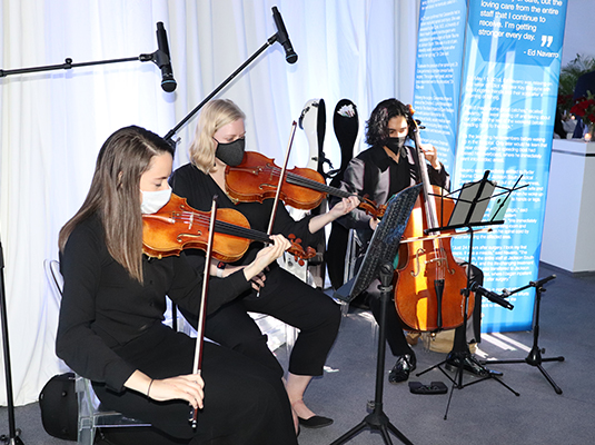 Three people playing musical instruments