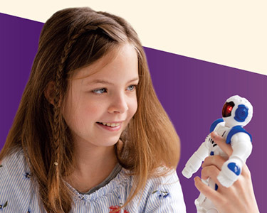 A young girl holding a small robotic toy