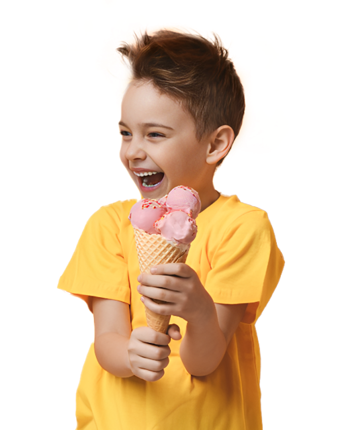 A young boy smiling, he is holding on to a large ice cream cone filled with scoops of ice cream