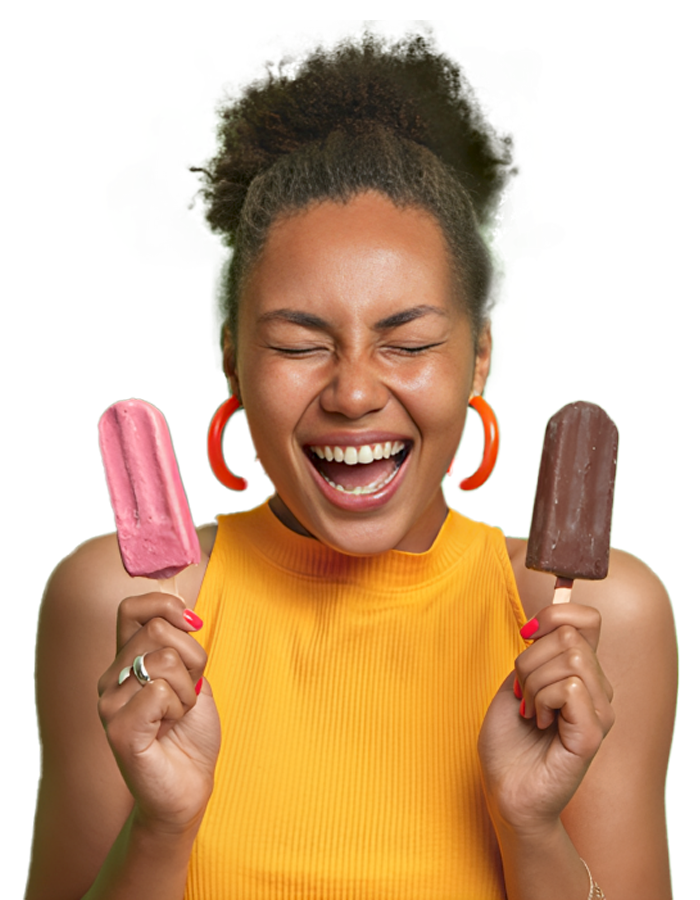 A woman smiling with her eyes closed, she is holding a popsicle within each hand