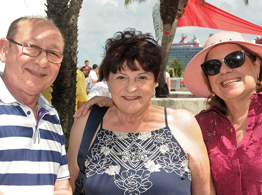 3 adult people smiling and posing to the camera