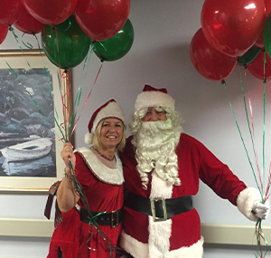 santa claus hugging woman in costume