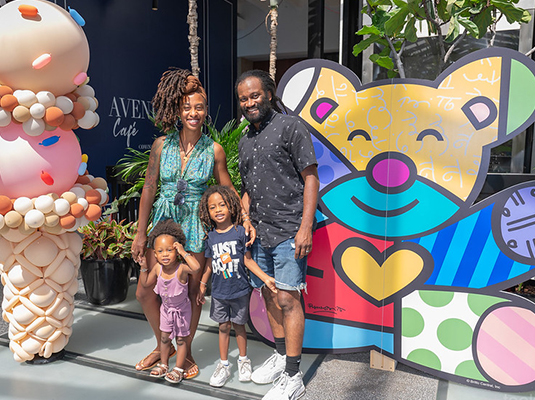 Family posing next to hospital decorations