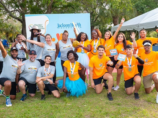 group of people posing and smiling at the camera