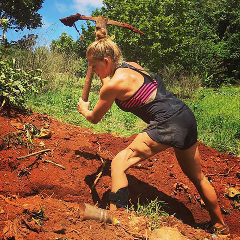 Danielle Press working on a farm, she is digging dirt