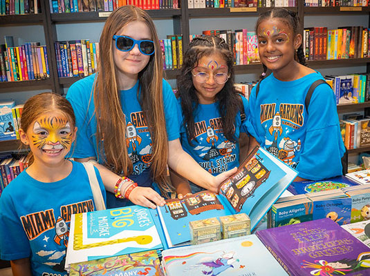 four girls watching books