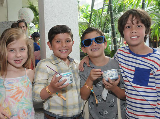 four children smiling and posing at the camera