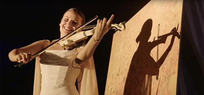 A woman playing a violin on a stage