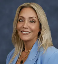 Woman with long blonde hair smiling at the camera