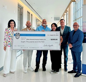 a group of people holding a giant check