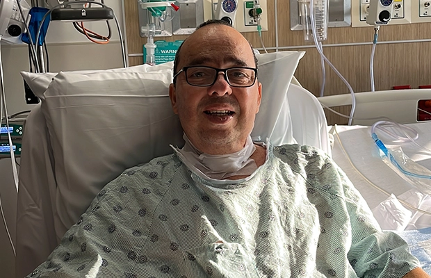 Man smiling from hospital gurney