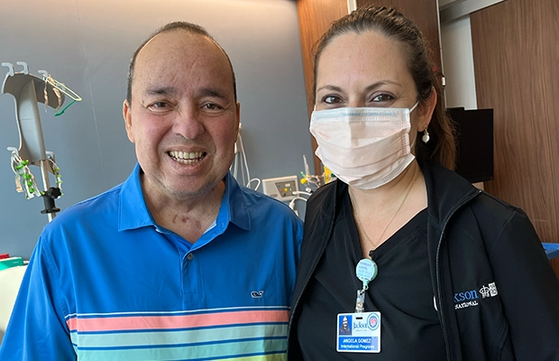 Man smiling next to woman wearing face mask