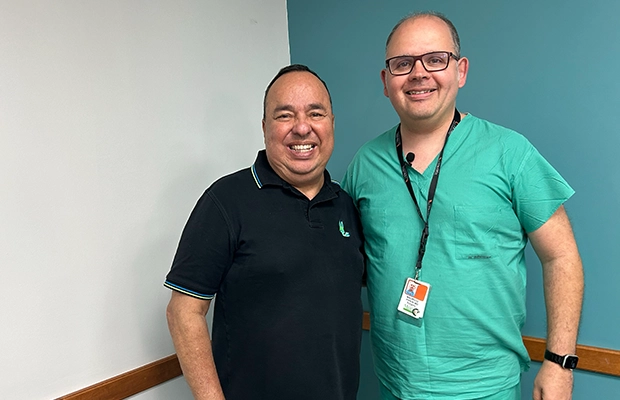 Man smiling next to a doctor