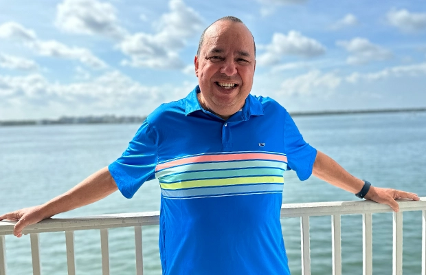 Man smiling from a hawk by the sea