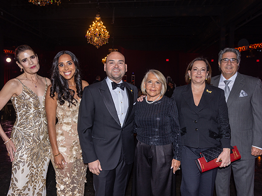 six people dressed in evening dress during the event