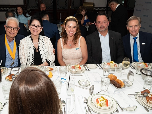 group of people eating at a formal event