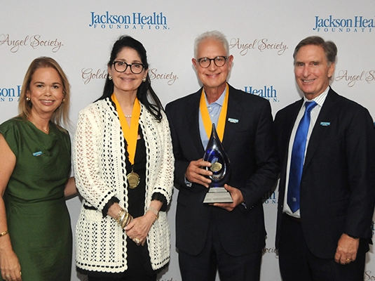 four people dressed up during an event