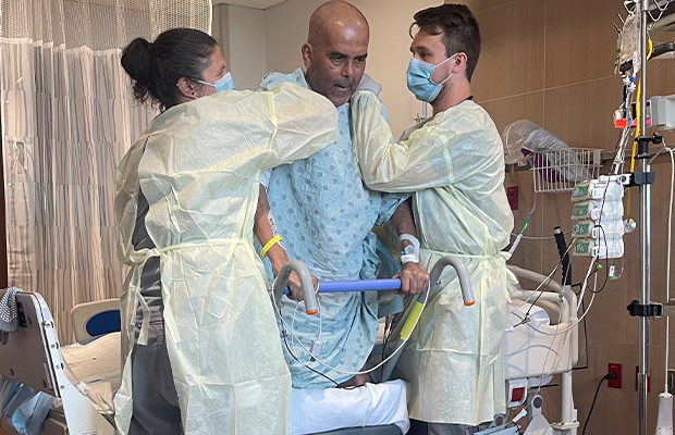 man undergoing therapy with a nurse and a doctor