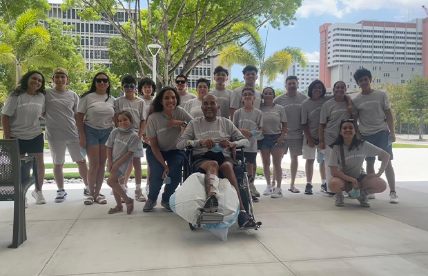 group of doctors next to a man in a wheelchair