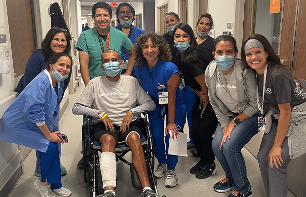 group of doctors next to a man in a wheelchair