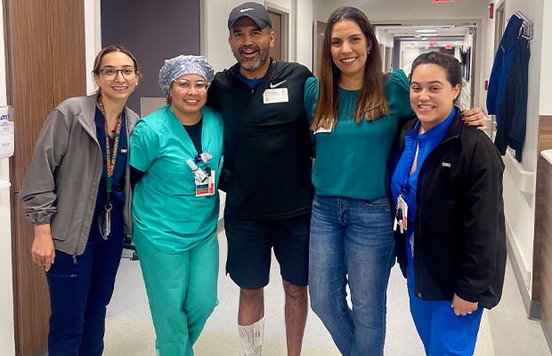 group of people smiling and posing in a hospital hallway
