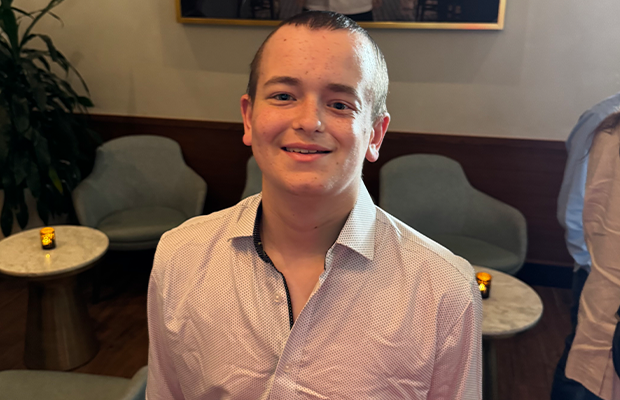 a young man posing and smiling at the camera