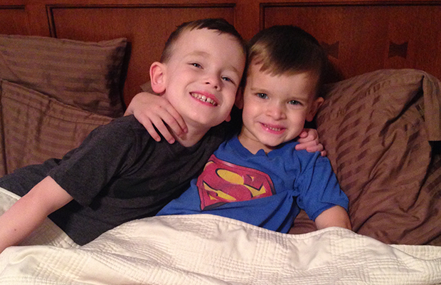 two children hugging in bed