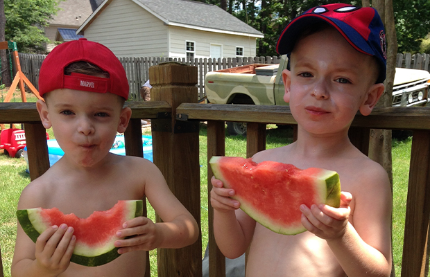 two children eating watermelon