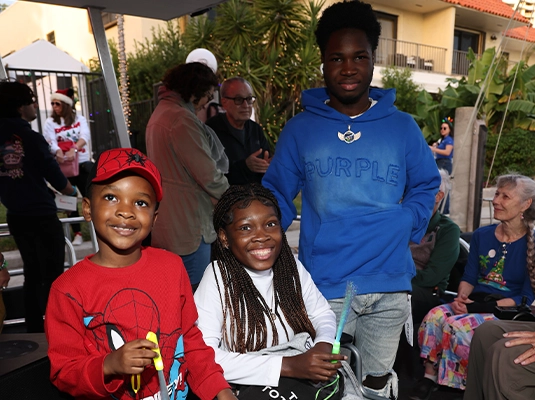 photograph of a child and two teenagers