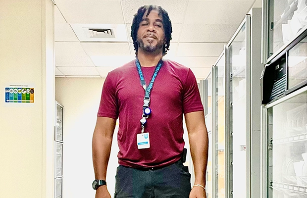 Man in a burgundy shirt posing for the camera