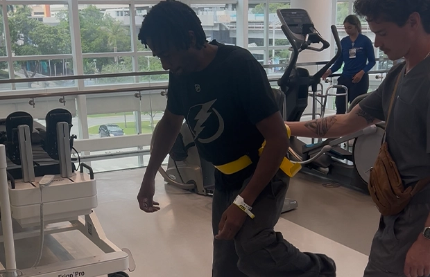 man undergoing therapy in the company of a nurse