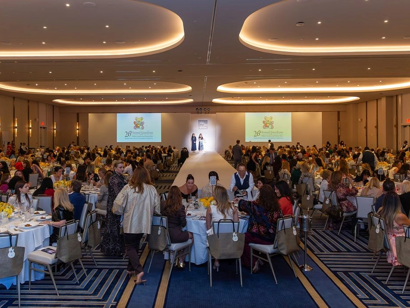 Image of a formal event filled with people.