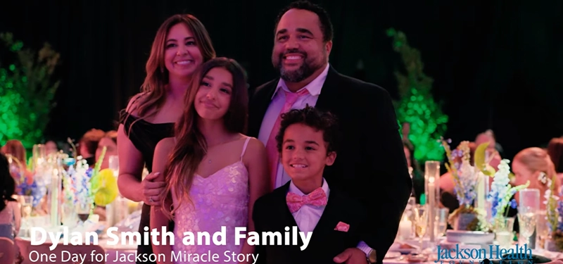 Family of four posing and smiling at the camera during a gala event